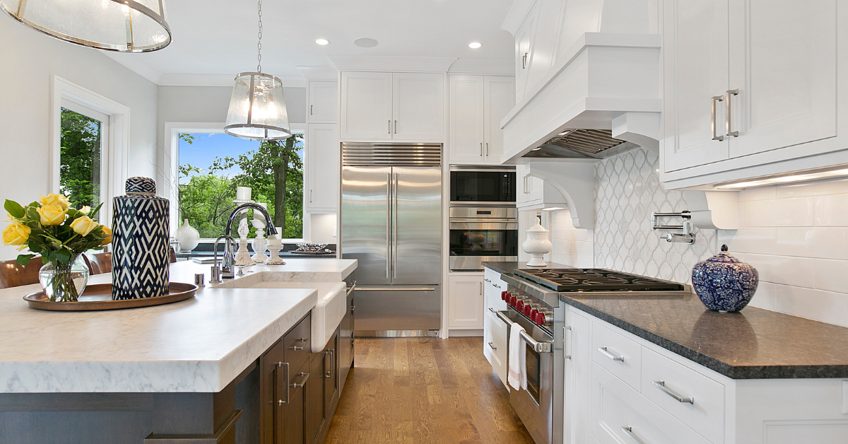 Traditional but bold kitchen renewal featuring black and white cabinets and commercial grade appliances.
