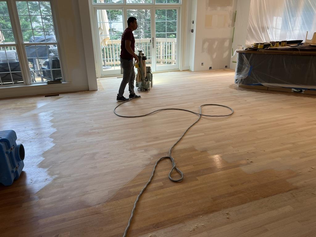 The Sanding and refinishing process makes the new and old sections of wood floor appear brand new.