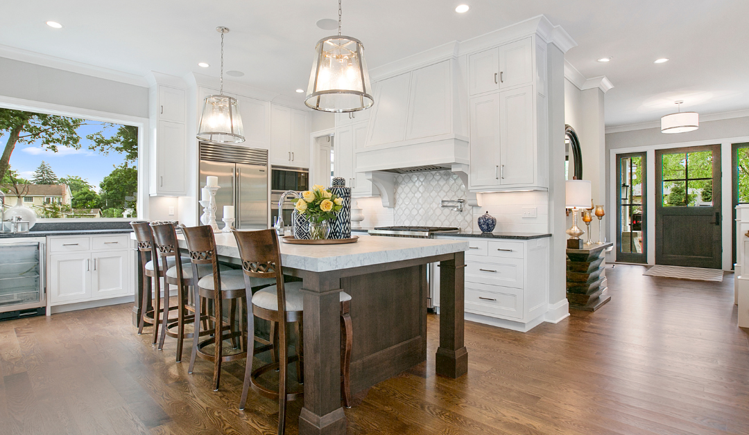 A completed kitchen remodel with white perimeter cabinets and a dark wood stained kitchen island.